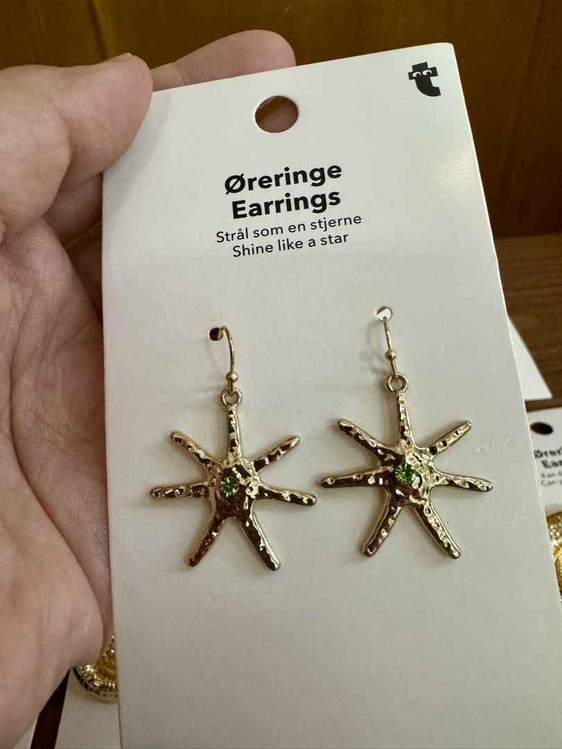 Flying Tiger Assorted Statement Earrings Nautilus Star Beaded Hoops (Category: Earrings) located in Quezon City. Submitted by appplebananna (Listing ID 1466469260, Image 3). Description: 150 pesos each 1000 pesos take all 10 pesos for paper bag - Condition: 100% Brand new, straight from packaging - Available Styles: Gold-tone nautilus seashell studs, star-shaped dangle earrings with green stones, and colorful beaded hoop earrings with hanging pea