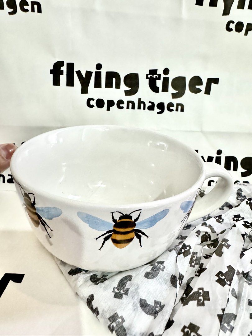Flying Tiger Copenhagen Bee Mug Bowl (Category: Coffee & Tea Tableware) located in Quezon City. Submitted by appplebananna (Listing ID 1466476937, Image 2). Description: - Authentic Flying Tiger Copenhagen large ceramic mug bowl - Adorable bumblebee design with blue wings and black-yellow stripes all around - Large, ergonomic handle for a comfortable and easy grip - Comes with the original Flying Tiger store bag, perfect for gifting.