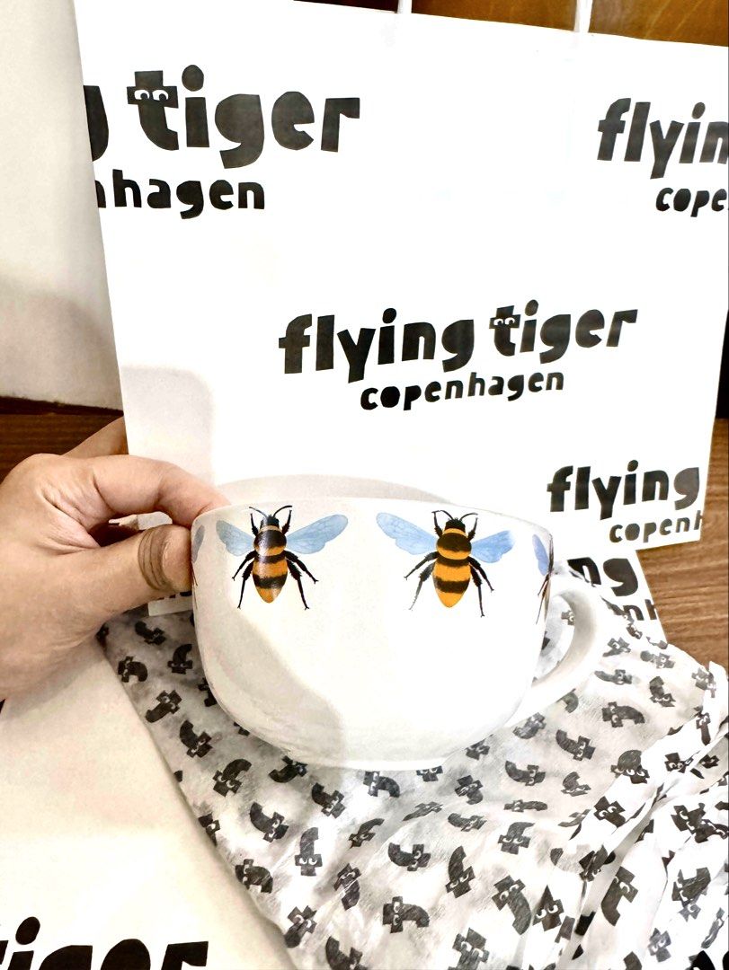 Flying Tiger Copenhagen Bee Mug Bowl (Category: Coffee & Tea Tableware) located in Quezon City. Submitted by appplebananna (Listing ID 1466476937, Image 1). Description: - Authentic Flying Tiger Copenhagen large ceramic mug bowl - Adorable bumblebee design with blue wings and black-yellow stripes all around - Large, ergonomic handle for a comfortable and easy grip - Comes with the original Flying Tiger store bag, perfect for gifting.