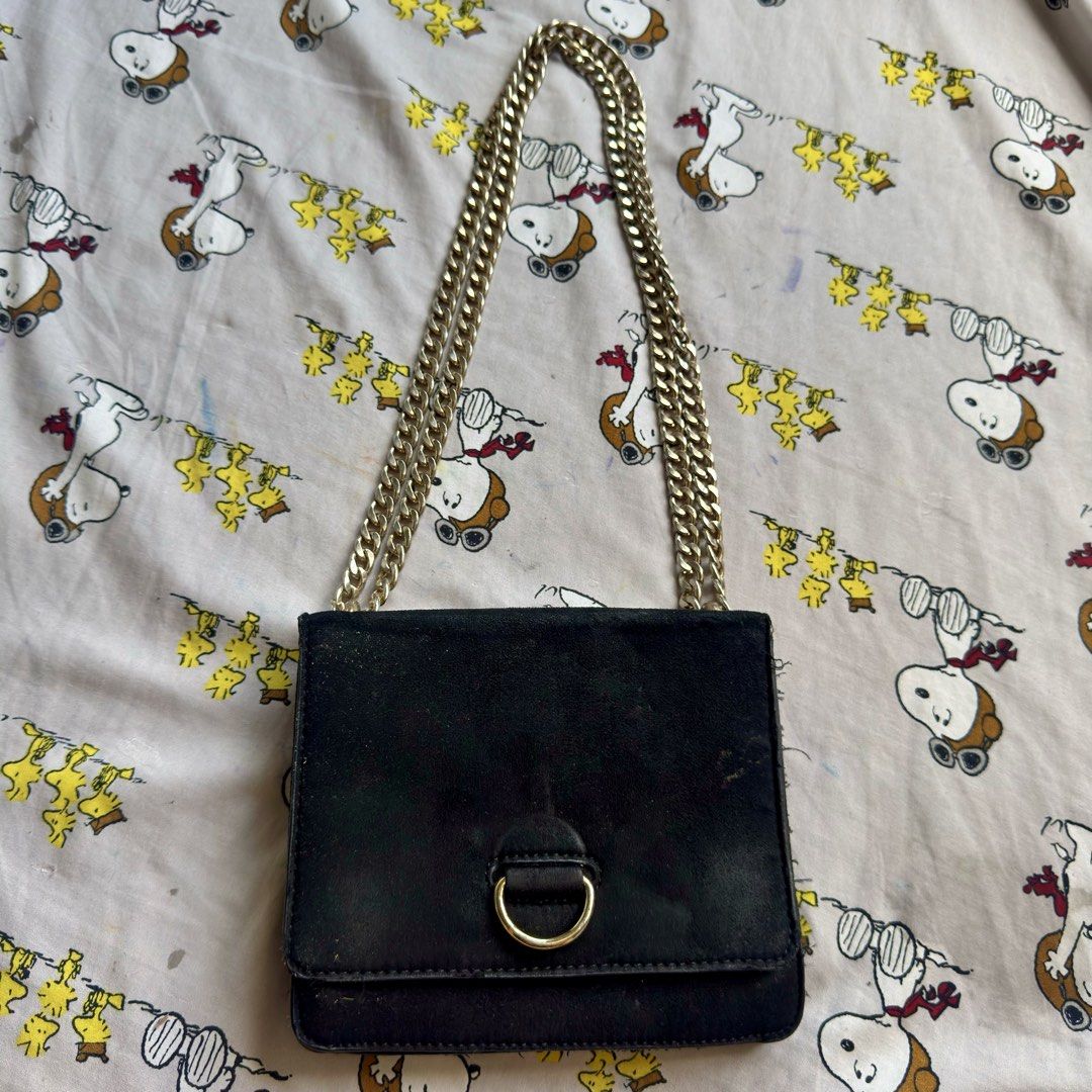 Forever 21 Black Suede Chain Bag (Category: Shoulder Bags) located in Marikina City. Submitted by preloved_n_reloved (Listing ID 1466413838, Image 1). Description: - Brand: Forever 21 - Material: 100% polyester black suede with dark brown inner lining - Strap: Stylish chunky gold chain - Closure: Small D-ring clasp on front flap - Details: Includes inside tag and care label, made in China - Style: Simple and chic shoulder bag.