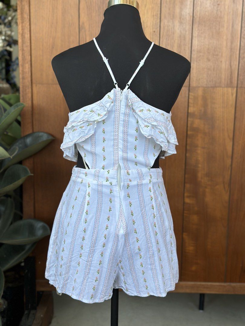 Forever 21 Floral Romper (Category: Rompers) located in Bulacan. Submitted by thriftbagcollections (Listing ID 1466359708, Image 3). Description: - Brand: Forever 21 - Size: M - Color/Pattern: White with vertical floral stripes - Features: Halter neck with adjustable straps, layered ruffle top overlay, stylish waist cutouts, and secure back zipper closure - Condition: Brand new with tag attached - Vibe: Cute, casual, and perfect for warm weather/