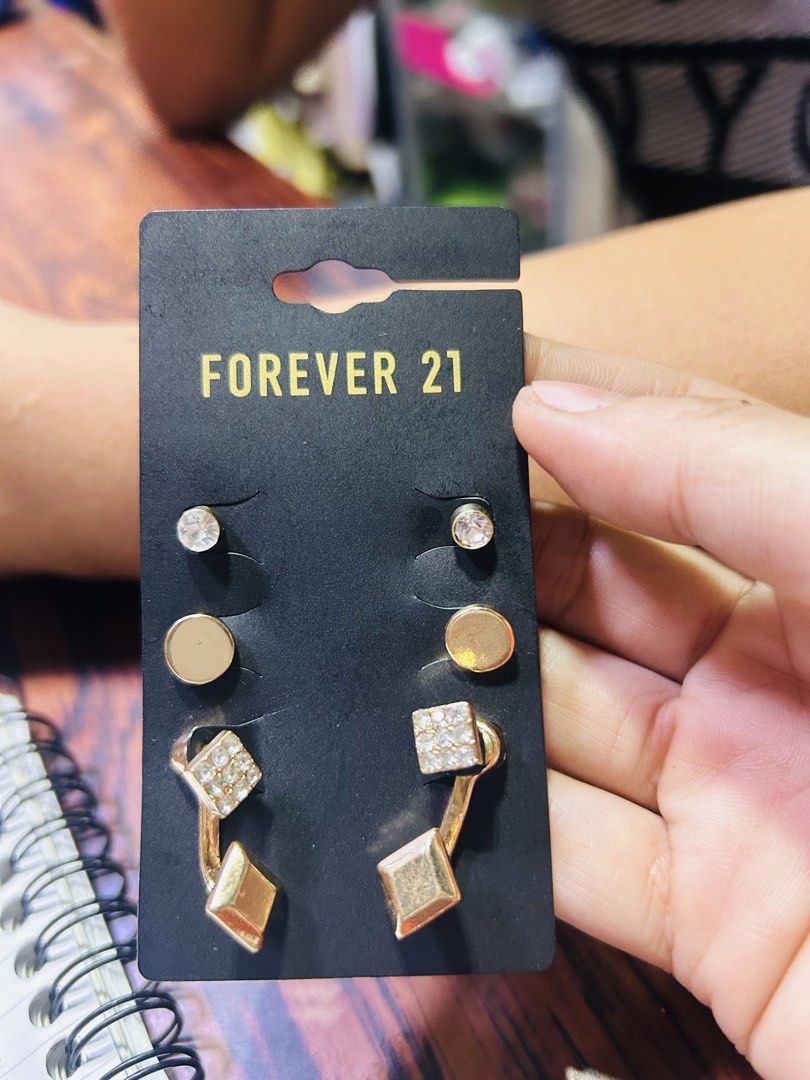 Forever 21 Gold and Clear Earring Set (Category: Earrings) located in Manila. Submitted by starbalesukandjapansurplus (Listing ID 1466500988, Image 1). Description: - Brand: Forever 21 - Quantity: Set of 3 pairs - Design: Gold-tone hardware, clear rhinestones, plain round studs, pave squares, and geometric dangles - Condition: Brand new, unused with original backing card and store tag - Perfect for daily wear or gifting!.