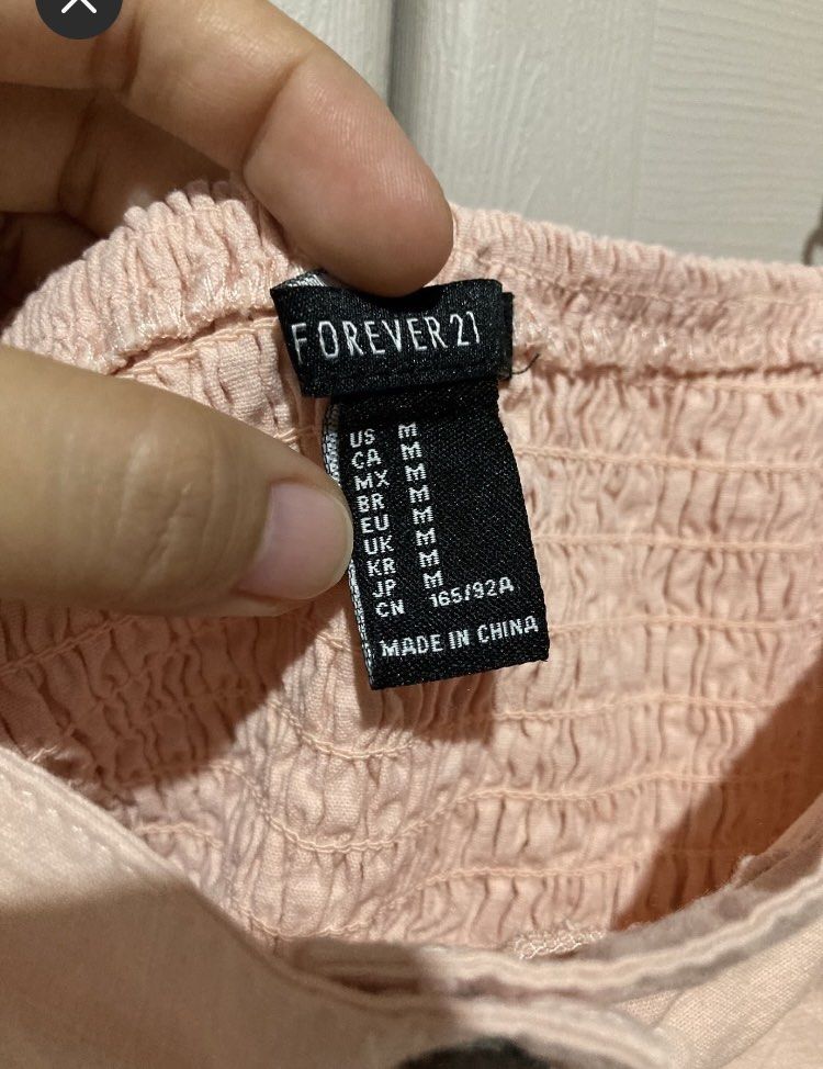 Forever 21 Pink Button-Front Mini Dress Size M (Category: Dresses) located in Meycauayan. Submitted by prettycloset.0310 (Listing ID 1466486728, Image 2). Description: Super cute Forever 21 pastel pink mini dress in size M. Features thick straps, a squared neckline, and a functional front button placket. The smocked back panel ensures a comfortable and flattering fit. Perfect and easy to style for casual daytime outings!.