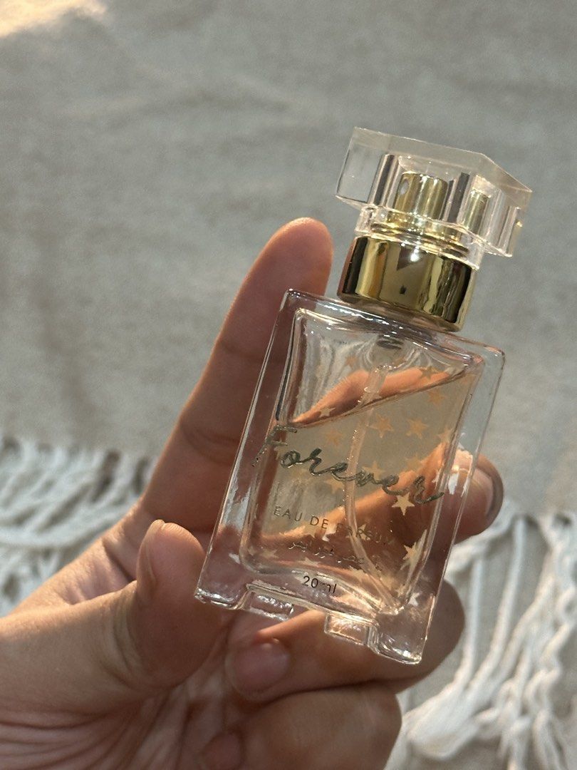 Forever Eau De Parfum 20ml (Category: Fragrance & Deodorants) located in Manila. Submitted by tenshiii185 (Listing ID 1466530410, Image 1). Description: Forever Eau De Parfum (20ml) in a travel-friendly glass bottle with a gold cap and cute star prints. About 75% left. Perfect pocket-sized everyday scent for your bag!.