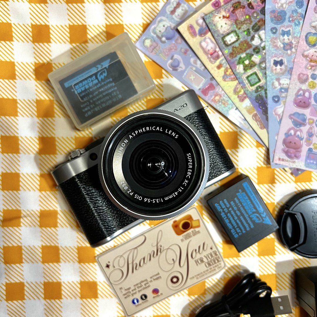 Fujifilm XA20 Mirrorless Camera (Category: Cameras) located in Makati City. Submitted by CameraHubPH (Listing ID 1466432748, Image 2). Description: 🎀 FUJIFILM X-A20 MIRRORLESS CAMERA 🎀 𐙚 ONE OF FUJIFILM’S UNDERRATED GEMS 𐙚 ✨ CAMERA DETAILS ✨ ♡ Fujifilm X-A20 Mirrorless ♡ XC 15-45mm OIS PZ Kit Lens ♡ Crisp & detailed image quality ♡ Built-in flash — working perfectly ⚡️ ♡ Autofocus working ♡ Zoom working ♡ LCD screen working ♡ Takes photos & v