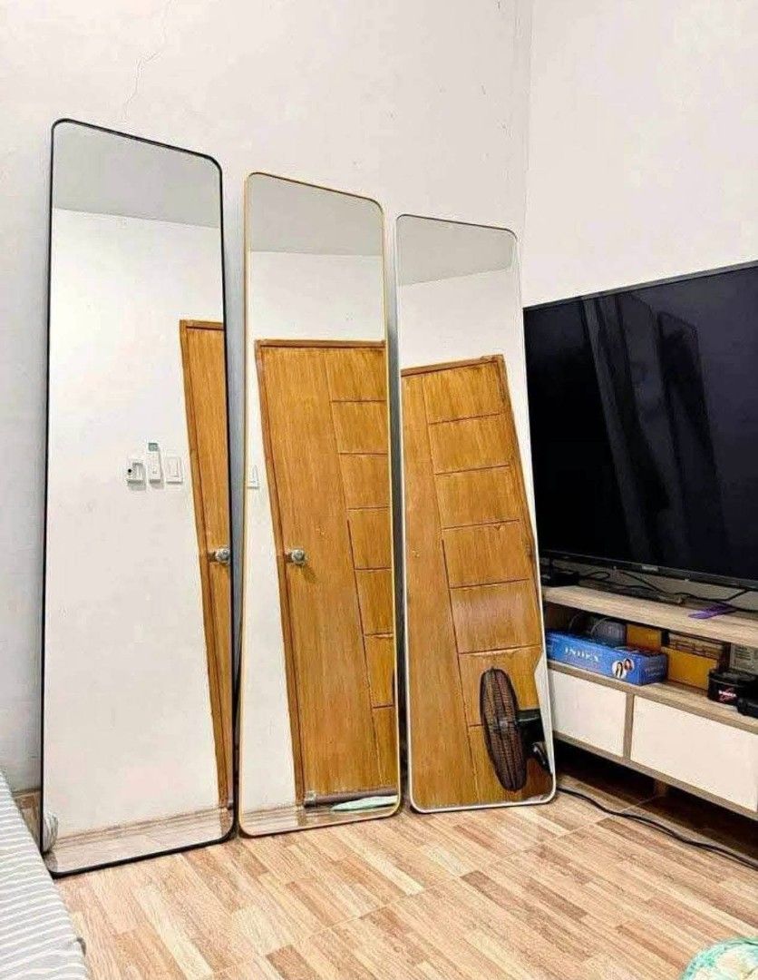 Full length standing mirror with frame (Category: Mirrors) located in Manila. Submitted by dryt1 (Listing ID 1466555700, Image 1). Description: Full length standing mirror leaning against the wall. Clean minimalist frame. Very tall, great for outfit checks before heading out. Solid build, stands securely on the floor. Moving houses soon, need to clear space quickly..