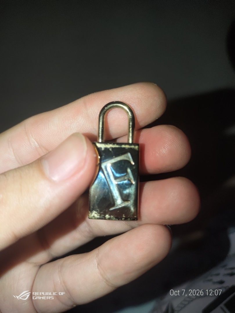 Furla Gold Padlock Bag Charm Hardware (Category: Luxury Accessories) located in Las Pinas. Submitted by choochiee (Listing ID 1466376110, Image 1). Description: - Brand: Furla - Material: Gold-tone metal - Design: Large engraved 'F' logo on front with stamped brand name on side - Hardware: Standard U-shaped shackle loop - Use: Ideal replacement part for handbags or as a stylish standalone charm - Condition: Minor surface scuffs from handling.