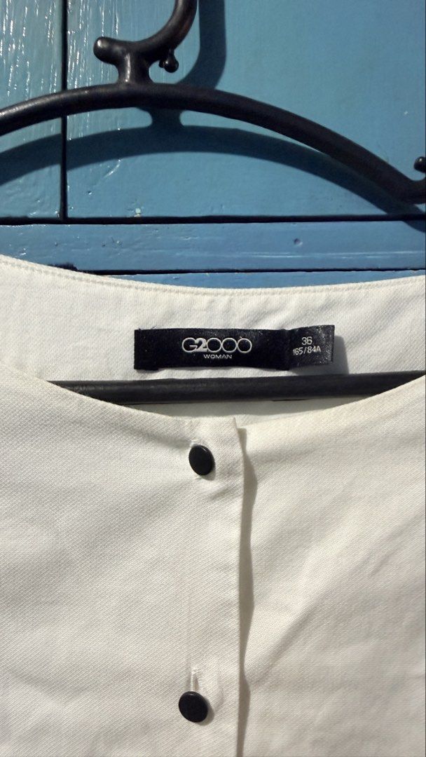 G2000 Woman White Button-Up Blouse (Category: Blouses) located in San Pablo. Submitted by dtanne (Listing ID 1466459826, Image 2). Description: - Brand: G2000 Woman - Color: Classic White with contrasting dark buttons - Size: 36 (165/84A) - Design: 3/4 sleeves with button cuffs and a flattering curved hem - Material: Lightweight fabric - Condition: Excellent pre-loved condition - Style: Ideal for office wear, interviews, or smart casual outfits.