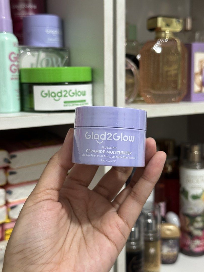 Glad2Glow Blueberry Ceramide Moisturizer 30g (Category: Face Care) located in Manila. Submitted by ystobeli (Listing ID 1466359382, Image 1). Description: - Product: Glad2Glow Blueberry Ceramide Moisturizer - Size: 30g / 1.05 oz (Full size, purple jar) - Condition: Brand new, factory-sealed with plastic wrap intact - Benefits: Soothes redness, calms acne, and smooths skin texture.