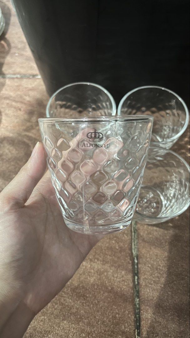 Glass cups and saucers set (Category: Coffee & Tea Tableware) located in Manila. Submitted by ayessaset53754 (Listing ID 1466378470, Image 2). Description: - Elegant matching set: honeycomb-textured clear glass cups with Alfonso I branding, swirl pattern cups, and ribbed glass saucers - Versatile and stylish: perfect for serving coffee or tea when hosting guests - Durable and practical: made with sturdy glassware that is very easy to wash - Reaso