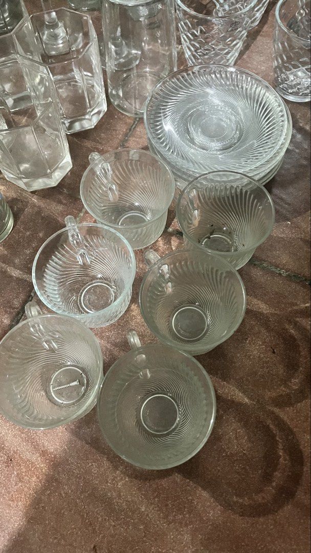 Glass cups and saucers set (Category: Coffee & Tea Tableware) located in Manila. Submitted by ayessaset53754 (Listing ID 1466378470, Image 3). Description: - Elegant matching set: honeycomb-textured clear glass cups with Alfonso I branding, swirl pattern cups, and ribbed glass saucers - Versatile and stylish: perfect for serving coffee or tea when hosting guests - Durable and practical: made with sturdy glassware that is very easy to wash - Reaso