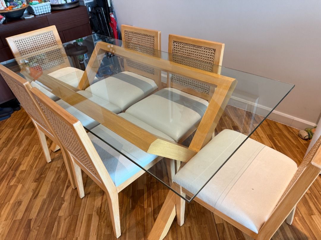Glass Dining Table and Six Chairs with Rattan Design (Category: Tables & Sets) located in Makati City. Submitted by peeveeimperial (Listing ID 1466480089, Image 2). Description: - Rectangular glass top dining table with light wooden base - Includes 6 matching chairs with rattan backrests and white leather upholstered cushions - Clean, modern design that fits most dining spaces comfortably - Removable glass top for easier transport and moving - We