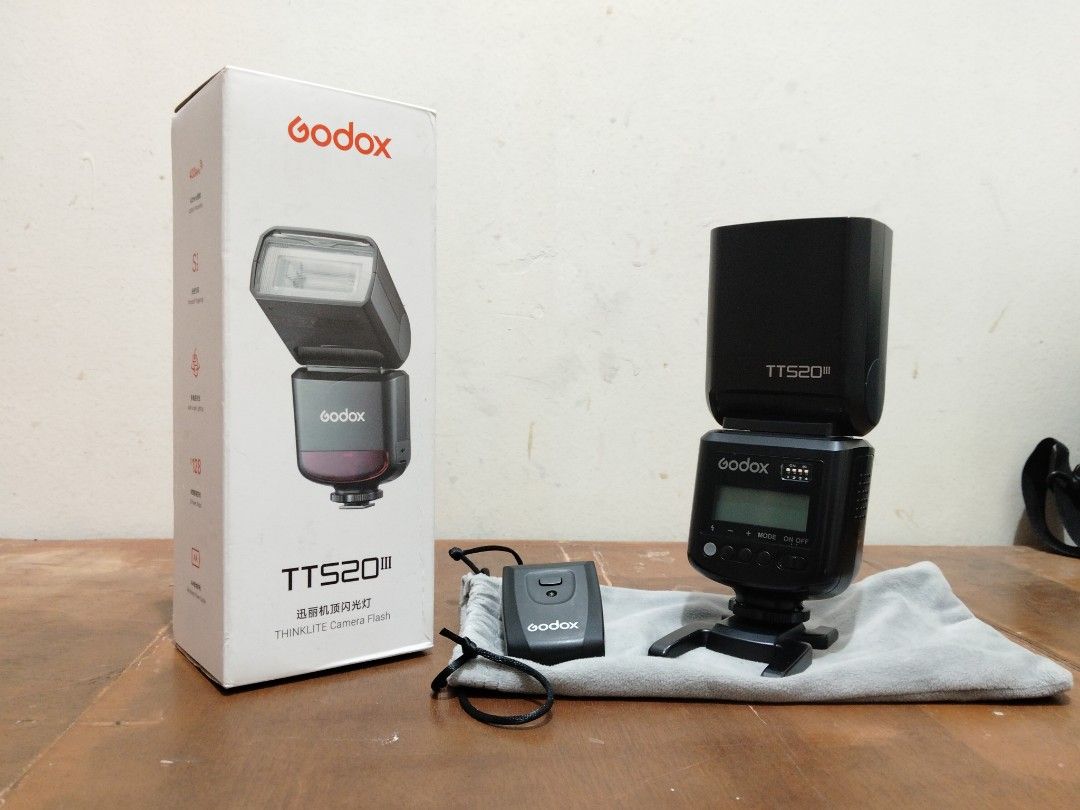 Godox Thinklite TTS20 III Camera Flash (Category: Flashes) located in Manila. Submitted by flx.zkl (Listing ID 1466515646, Image 1). Description: - Model: Godox Thinklite TTS20 III camera flash unit (Black) - Minor scratches - Condition: Fully functional, box shows minor handling wear - Power Source: Runs on standard AA batteries - Includes: Original retail box, mini flash stand, storage pouch, and wireless trigger - Perfect for portable and stud