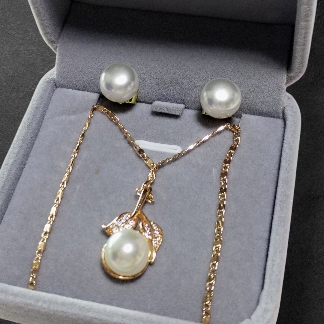 Gold Plated Pearl Necklace & Earring Set (Category: Body Jewelry) located in San Juan City. Submitted by exclusivelyours (Listing ID 1466431501, Image 1). Description: Elegant gold-tone set featuring a pearl pendant necklace with crystal-accented leaf details and matching pearl stud earrings. Comes in a soft velvet gift box. Perfect for everyday wear or special occasions..