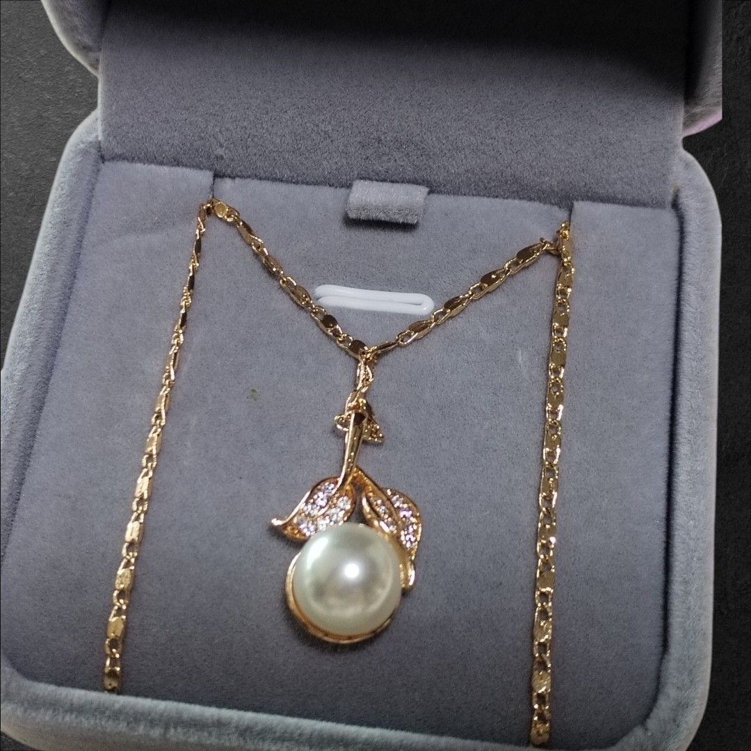 Gold Plated Pearl Necklace & Earring Set (Category: Body Jewelry) located in San Juan City. Submitted by exclusivelyours (Listing ID 1466431501, Image 2). Description: Elegant gold-tone set featuring a pearl pendant necklace with crystal-accented leaf details and matching pearl stud earrings. Comes in a soft velvet gift box. Perfect for everyday wear or special occasions..