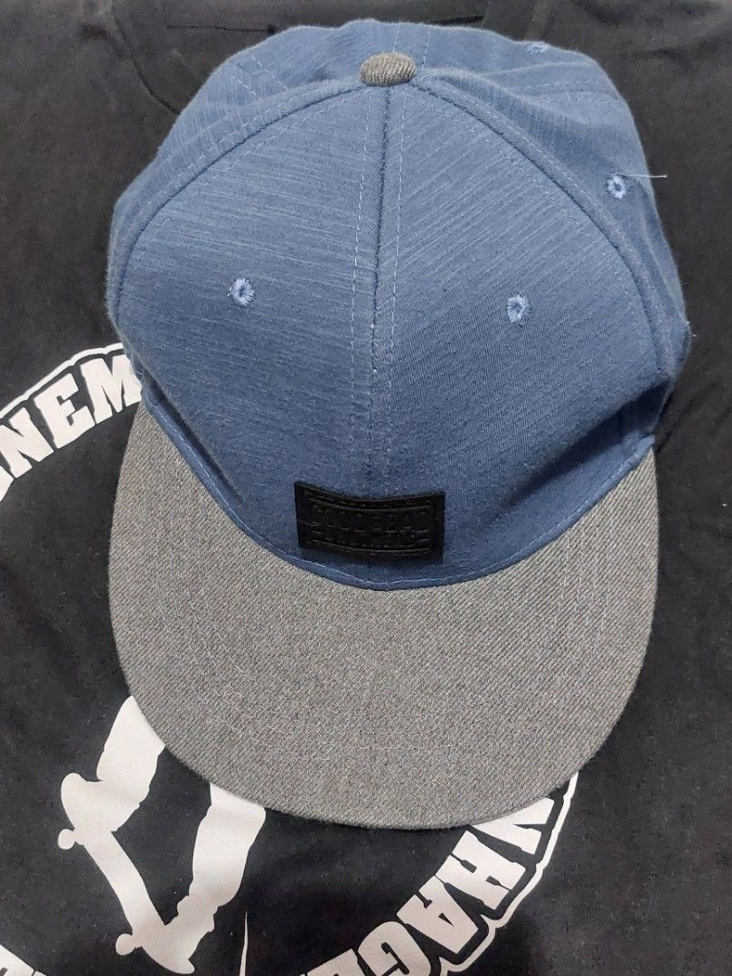 Good & Bad Snapback Cap Blue Grey (Category: Caps & Hats) located in Sorsogon. Submitted by johnsarchive.ph (Listing ID 1466523635, Image 1). Description: - Color: Blue and Grey - Design: Structured crown with a flat brim - Fit: Adjustable plastic strap at the back - Details: Interior taping branded with 'Find Balance' - Condition: Clean fabric inside and out - Style: Great everyday hat that goes with almost anything.