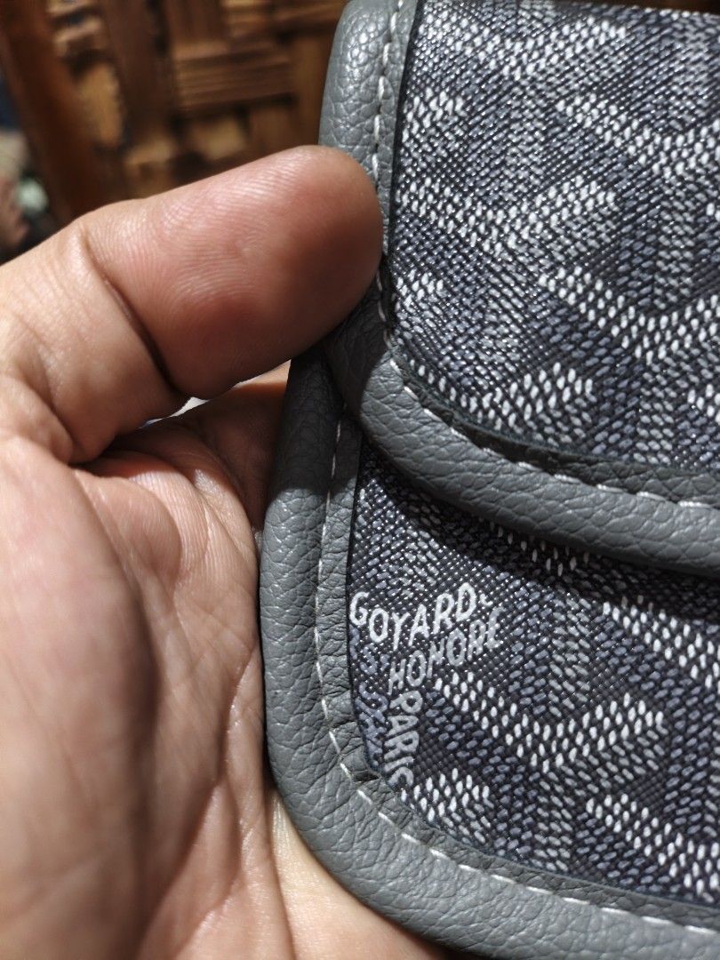 Goyard Grey Chevron Pattern Wallet (Category: Luxury Bags & Wallets) located in Maasim. Submitted by ukayganda25 (Listing ID 1466479208, Image 3). Description: - Brand: Goyard Wallet - Color/Design: Classic grey with chevron print and leather trim - Closure: Secure silver snap button on the front flap - Details: Stamped logo near the edge with clean stitching throughout - Size: Compact and practical for daily use - Condition: Excellent.