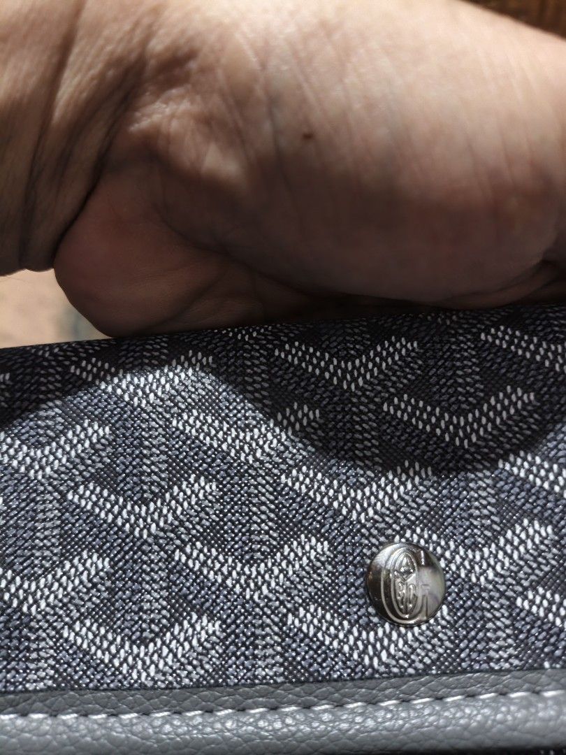 Goyard Grey Chevron Pattern Wallet (Category: Luxury Bags & Wallets) located in Maasim. Submitted by ukayganda25 (Listing ID 1466479208, Image 2). Description: - Brand: Goyard Wallet - Color/Design: Classic grey with chevron print and leather trim - Closure: Secure silver snap button on the front flap - Details: Stamped logo near the edge with clean stitching throughout - Size: Compact and practical for daily use - Condition: Excellent.