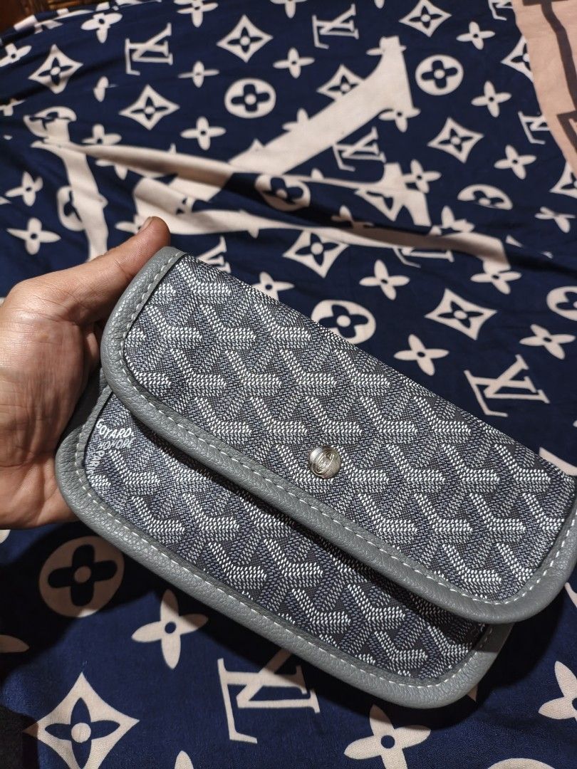 Goyard Grey Chevron Pattern Wallet (Category: Luxury Bags & Wallets) located in Maasim. Submitted by ukayganda25 (Listing ID 1466479208, Image 1). Description: - Brand: Goyard Wallet - Color/Design: Classic grey with chevron print and leather trim - Closure: Secure silver snap button on the front flap - Details: Stamped logo near the edge with clean stitching throughout - Size: Compact and practical for daily use - Condition: Excellent.