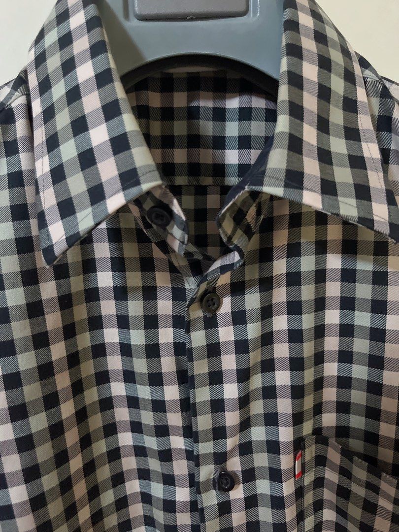 GQ plaid short sleeve button up shirt (Category: Tshirts & Polo Shirts ) located in Manila. Submitted by _preciousfinds.2 (Listing ID 1466519208, Image 3). Description: - Brand/Model: GQ Short Sleeve Button-Up Shirt - Color/Pattern: Black, white, and muted green plaid check - Details: Classic collar, front button closure, single chest pocket with red tab accent - Fit: relaxed fit - Material: extra cotton - Style: Ideal for casual or smart casual 