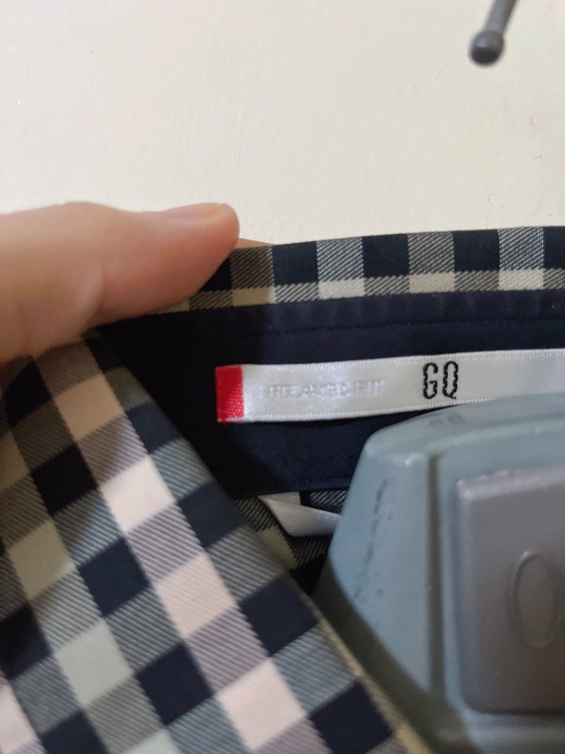 GQ plaid short sleeve button up shirt (Category: Tshirts & Polo Shirts ) located in Manila. Submitted by _preciousfinds.2 (Listing ID 1466519208, Image 2). Description: - Brand/Model: GQ Short Sleeve Button-Up Shirt - Color/Pattern: Black, white, and muted green plaid check - Details: Classic collar, front button closure, single chest pocket with red tab accent - Fit: relaxed fit - Material: extra cotton - Style: Ideal for casual or smart casual 