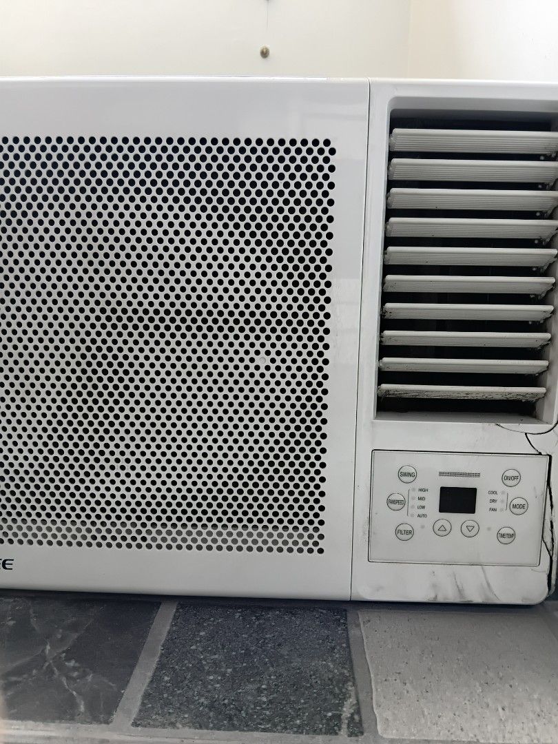 Gree Window Air Conditioner Unit (Category: Air Conditioning and Heating) located in Manila. Submitted by ciciandgigi (Listing ID 1466386040, Image 2). Description: - Type: White window air conditioner - Controls: Digital panel with Cool, Dry, and Fan modes - Features: Adjustable louvers and front mesh grille - Power: Standard plug included - Condition: Working well, with minor dirt, stains, and paint chips around the edges from normal use.