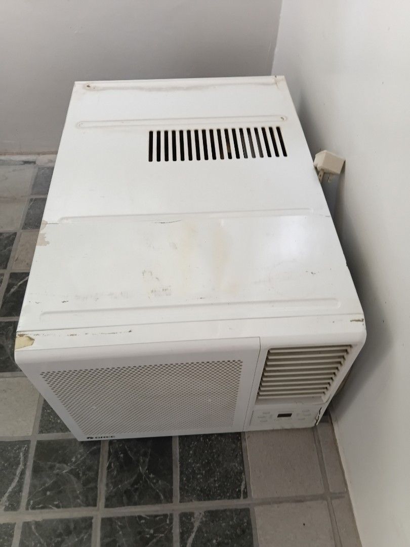 Gree Window Air Conditioner Unit (Category: Air Conditioning and Heating) located in Manila. Submitted by ciciandgigi (Listing ID 1466386040, Image 1). Description: - Type: White window air conditioner - Controls: Digital panel with Cool, Dry, and Fan modes - Features: Adjustable louvers and front mesh grille - Power: Standard plug included - Condition: Working well, with minor dirt, stains, and paint chips around the edges from normal use.