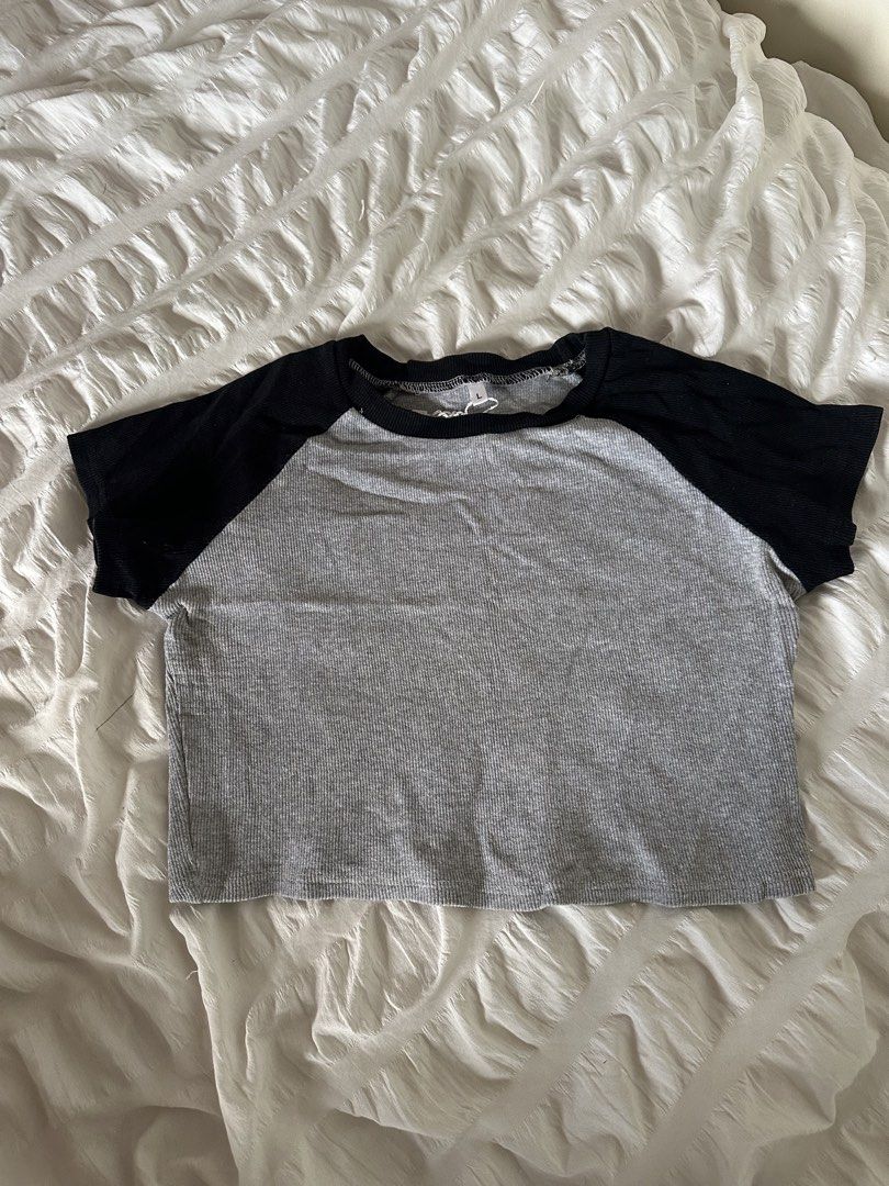 Grey and Black Raglan Short Sleeve Crop Top (Category: Shirts) located in Mandaluyong City. Submitted by youarecutejeans (Listing ID 1466440819, Image 1). Description: - Style: Casual streetwear crop top - Design: Grey ribbed texture with black contrast raglan sleeves and collar - Size: Large - Condition: Clean and ready to wear - Pairing: Easy to match with high-waisted jeans or shorts.
