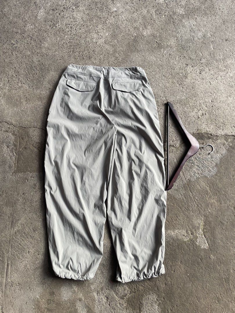 Grey Parachute Cargo Pants with Drawstring Waist (Category: Trousers) located in General Santos City (Dadiangas). Submitted by christbluee (Listing ID 1466559975, Image 3). Description: - Style: Grey nylon cargo pants with a relaxed wide-leg fit - Fit & Adjustability: Drawstring waist and cuffs for customizable styling - Pockets: Two rear button flap pockets - Material: Lightweight with a slight crinkle texture, ideal for streetwear or casual wea