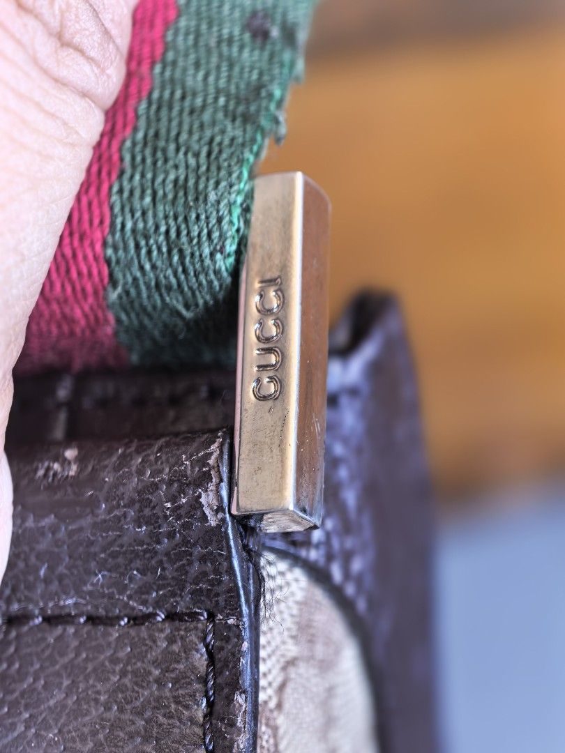 Gucci GG Monogram Canvas Shoulder Bag (Category: Luxury Bags & Wallets) located in Cagayan de Oro. Submitted by tommygurl1218 (Listing ID 1466401229, Image 2). Description: - Gucci shoulder bag in classic brown GG monogram canvas - Iconic green and red striped web strap with silver-tone Gucci hardware - Secure top zipper closure with branded metal pull - Trendy and compact crescent shape, ideal for daily use - Condition: Slight wear on the leathe