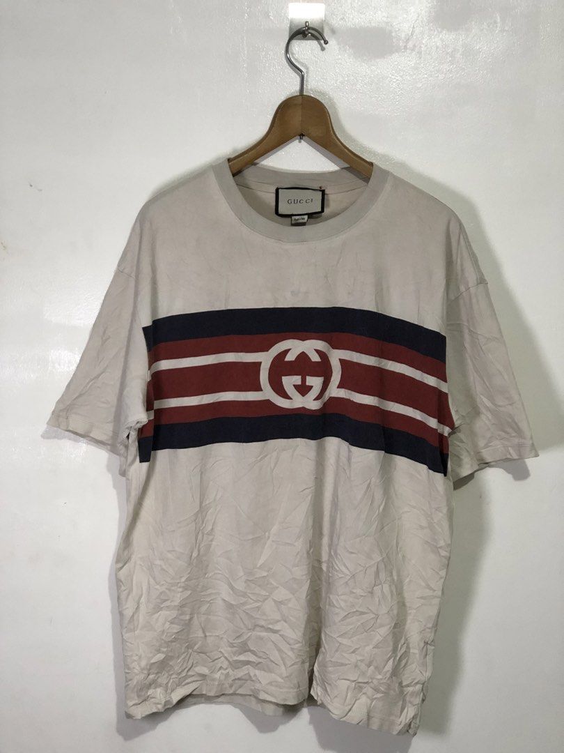 Gucci Interlocking G Stripe T-shirt Size M (Category: Tshirts & Polo Shirts ) located in Quezon City. Submitted by clarizedeo09960 (Listing ID 1466499109, Image 1). Description: - Brand: Gucci - Color: Off-white - Size: Medium (regular fit) - Material: Comfortable cotton (Made in Italy) - Design: Classic stripe chest band with interlocking G logo - Condition/Details: Neck tag and wash label attached - Style: Easy streetwear piece.