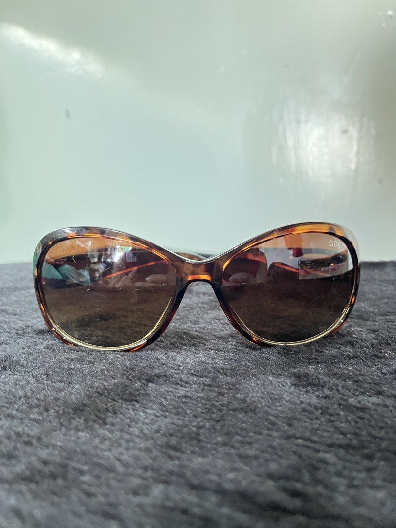 Gucci Tortoiseshell Sunglasses (Category: Sunglasses & Eyewear) located in Baguio. Submitted by arnulfoaz (Listing ID 1466383983, Image 2). Description: Authentic Gucci tortoiseshell sunglasses with brown gradient lenses. Classic oval frames, tortoise print acetate. Distinctive silver metal hardware and logo detailing on the temples. Made in Italy. Normal wear on lenses and frame. - minor scratches - accepting best offers.