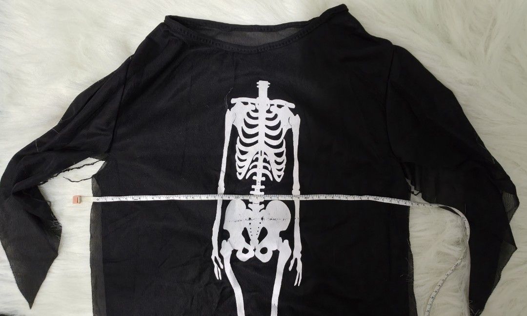 Halloween skeleton costume with mask (Category: Babies & Kids Fashion) located in Bacoor. Submitted by lakasa (Listing ID 1466412856, Image 3). Description: - Complete black skeleton costume set - Includes long sleeve tunic with white skeleton print and jagged sheer sleeves - Comes with a classic screaming ghost face ftee mask - Measurements: 27 inches length, 22 inches chest width across - Easy to wear over regular pants - Ideal for Halloween pa
