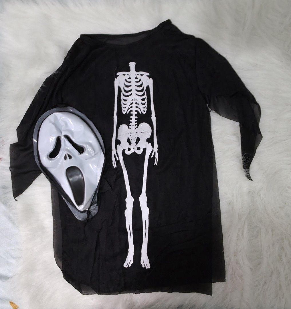 Halloween skeleton costume with mask (Category: Babies & Kids Fashion) located in Bacoor. Submitted by lakasa (Listing ID 1466412856, Image 1). Description: - Complete black skeleton costume set - Includes long sleeve tunic with white skeleton print and jagged sheer sleeves - Comes with a classic screaming ghost face ftee mask - Measurements: 27 inches length, 22 inches chest width across - Easy to wear over regular pants - Ideal for Halloween pa