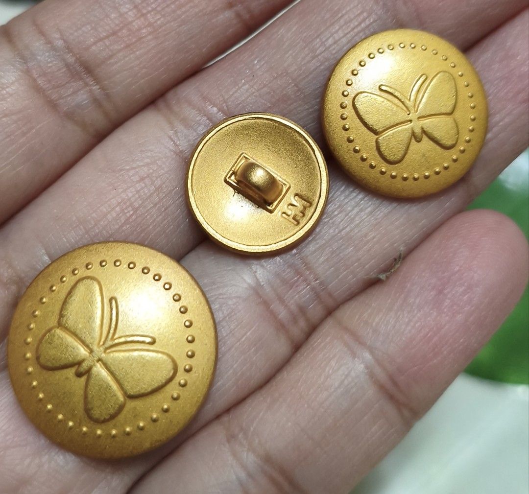 Hanae Mori Gold Butterfly Pattern Buttons (Category: Earrings) located in Quezon City. Submitted by gemaicloset (Listing ID 1466354526, Image 1). Description: - Brand: Hanae Mori - Quantity: Set of 4 gold-tone buttons - Design: Raised butterfly motif with dot patterns and matte finish - Backing: Shank style with stamped signature logo - Material: Heavy metal construction - Ideal for: Sewing projects or replacing jacket hardware.