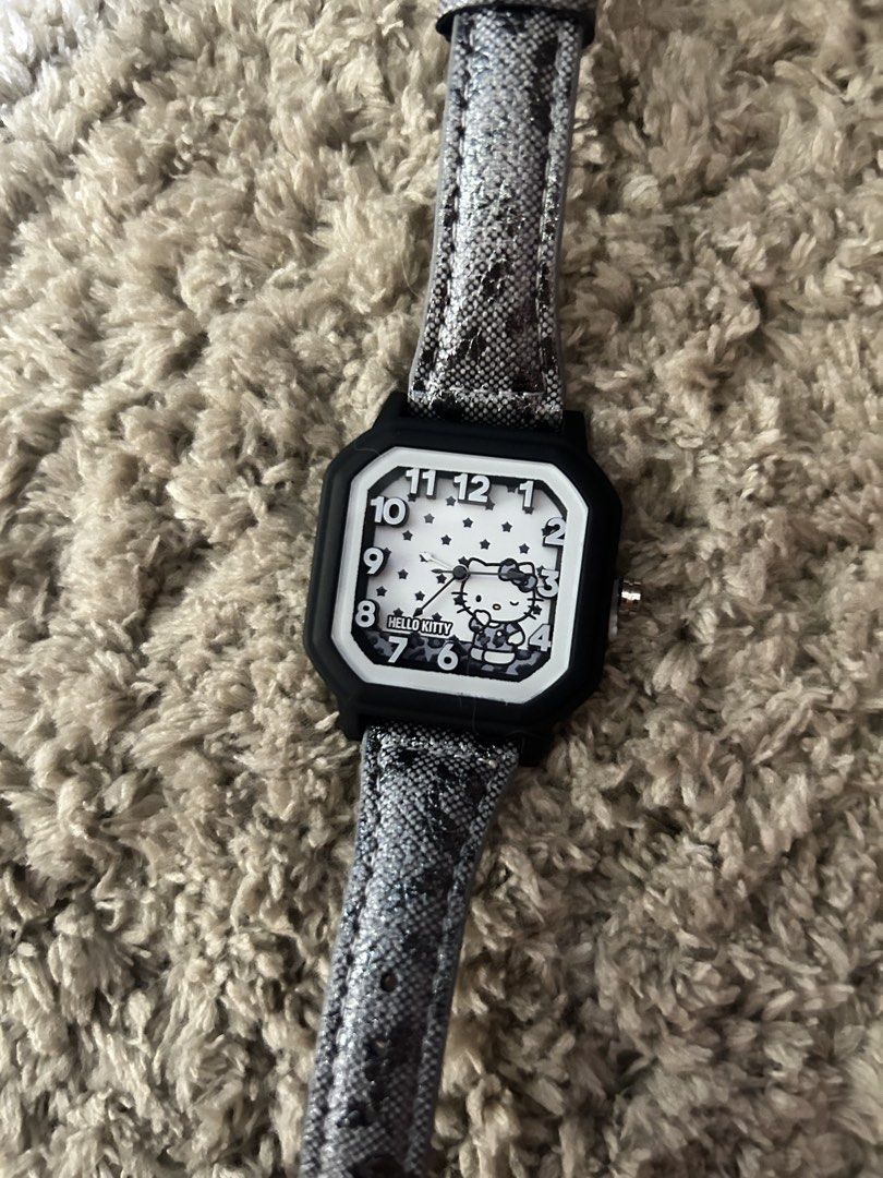 Hello Kitty Leopard Watch Black White (Category: Women's Watches) located in Cavite. Submitted by zacharyyy__ (Listing ID 1466434403, Image 1). Description: - Authentic Sanrio Kitty watch from the Moetch Sweet Heart Leopard series - Stylish black & white dial with star pattern and trendy black square frame - Chic grey animal print strap - Condition: Brand new / Unused (pulled from blind box packaging) - Includes original box with official Sanrio 