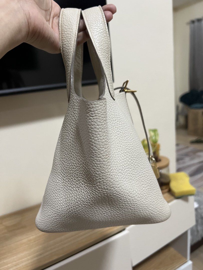Hermes Picotin Lock White Leather Tote Bag (Category: Luxury Bags & Wallets) located in Cauayan City . Submitted by best_buyph_88 (Listing ID 1466357910, Image 2). Description: - White pebbled leather bucket bag - Gold-tone hardware with dual top handles - Padlock with strap closure & 4 protective base feet - Flat bottom structure keeps bag upright - Flaw: Unlined raw suede interior has noticeable ink stains and discoloration -self authenticate s
