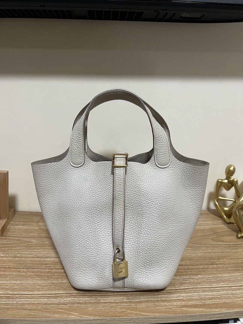 Hermes Picotin Lock White Leather Tote Bag (Category: Luxury Bags & Wallets) located in Cauayan City . Submitted by best_buyph_88 (Listing ID 1466357910, Image 1). Description: - White pebbled leather bucket bag - Gold-tone hardware with dual top handles - Padlock with strap closure & 4 protective base feet - Flat bottom structure keeps bag upright - Flaw: Unlined raw suede interior has noticeable ink stains and discoloration -self authenticate s