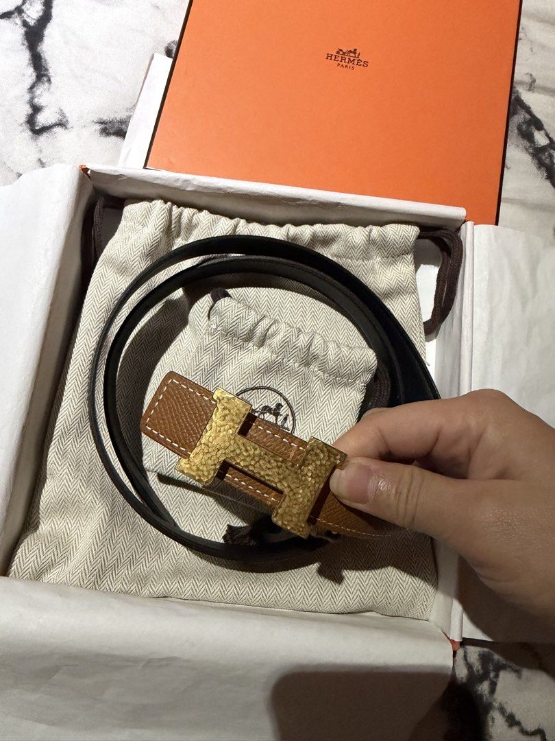 Hermes Reversible Belt with Gold H Buckle (Category: Luxury Accessories) located in Dasmarinas. Submitted by joy_declutteringacct (Listing ID 1466501436, Image 3). Description: Complete Inclusions Brand new - Authentic Hermes reversible leather belt (Brown on one side, Black on the other) - Textured gold-tone H buckle with a stylish hammered finish - Beautiful white contrast stitching along the brown leather side - Brand new with tag still attach