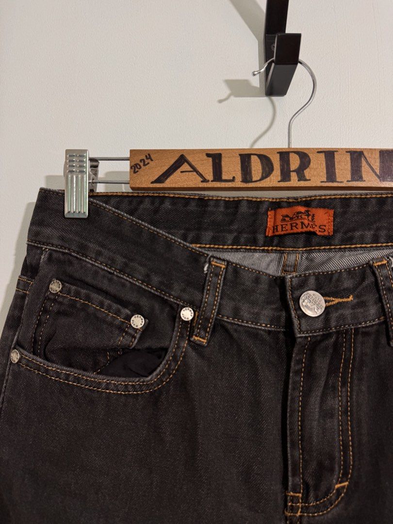 Hermès Black Denim Jeans (Category: Jeans) located in Cavite. Submitted by aldrindela40142 (Listing ID 1466484885, Image 3). Description: - Brand: Hermès - Item: Black denim jeans - Size: Labeled 30-31 (Length: 41 inches) - Details: Contrast orange stitching and branded silver-tone hardware - Branding: Orange interior waistband label, black leather back waist patch, and metal Hermès pocket tag - Condition: Excellent, 100% authentic - Shipping: Sh
