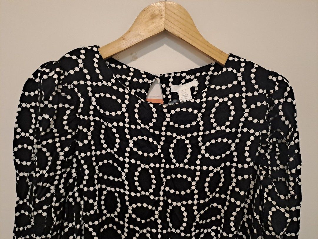 H&M DRESS (Category: Dresses) located in Manila. Submitted by joanbalde39643 (Listing ID 1466441255, Image 3). Description: This item is a black and white bead print open-back long sleeve mini dress by H&M. It features a round neckline with a keyhole back closure, long sleeves, and a distinctive geometric pattern composed of connected white dots mimicking strings of pearls or beads..