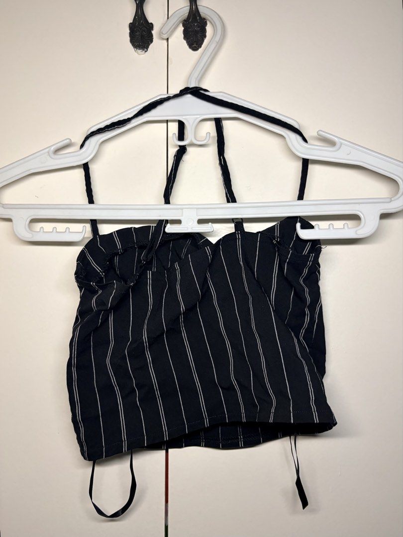 Black & White Pinstriped Halter Crop Top (Category: Sleeveless) located in Paranaque City. Submitted by honeykkkk (Listing ID 1466483725, Image 2). Description: • Details: Classic black base with thin white pinstripes, halterneck silhouette with adjustable halter tie straps, sweetheart/straight neckline, and internal hanger loops for convenient storing. Trendy Y2K/casual style that pairs easily with high-waisted trousers, skirts, or denim. • Cond