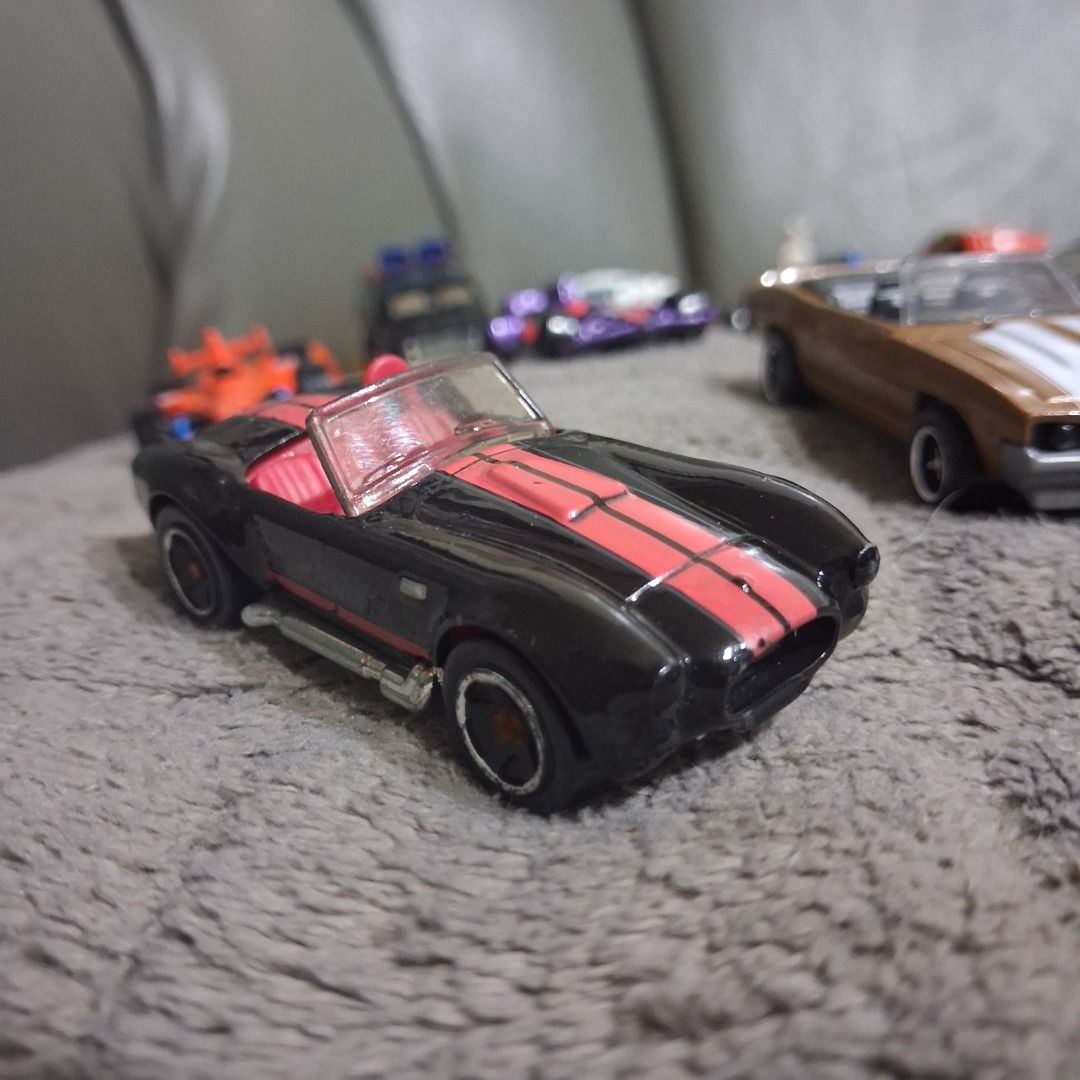 Hot Wheels Toy Car Assorted Collection Die-Cast Models (Category: Vehicle & Diecast Models) located in Caloocan City. Submitted by brex20 (Listing ID 1466510914, Image 1). Description: - Bundle of Hot Wheels die-cast toy cars - Variety of models including classic convertibles, muscle cars with exposed engines, and racing cars - Assorted colors such as metallic blue, red with flames, and glossy black with red stripes - Great for expanding a collec