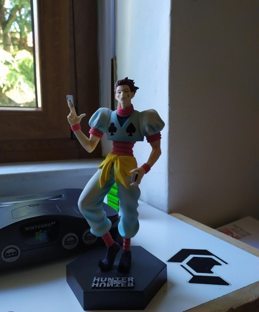 Hunter x Hunter Hisoka BIB (Category: Action & Battle Toys) located in Caloocan City. Submitted by marvinchan139 (Listing ID 1466488670, Image 1). Description: - Character: Hisoka from Hunter x Hunter - Pose: Holding playing cards in his signature outfit and hairstyle - Base: Mounted on a stylish black hexagonal base with the official series logo - Quality: Stands upright with clean, detailed paint work on the clothing and face markings - Perfect
