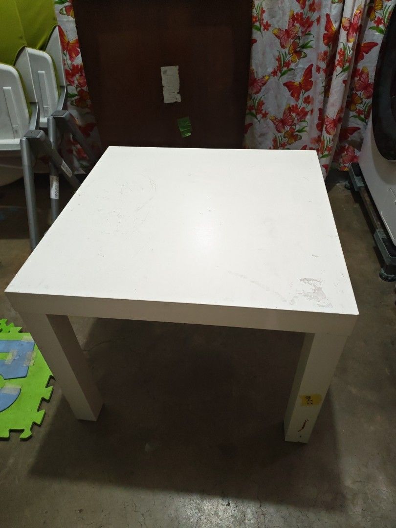 IKEA LACK side table white (Category: Tables & Sets) located in Manila. Submitted by aks_japansurplus30 (Listing ID 1466393717, Image 1). Description: - Authentic IKEA LACK side table in classic white - Compact square design with four sturdy legs 55cmx55cm - Original model sticker (21072) intact underneath - Fully functional and sturdy, perfect as a bedside or sofa table - Please note: Shows cosmetic wear, including scuffs and scratches from prev