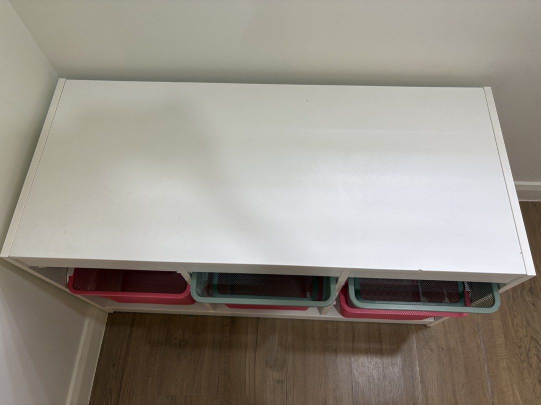 IKEA Trofast Storage Unit with Mesh Bins (Category: Shelves, Cabinets & Racks) located in Quezon City. Submitted by emmakne (Listing ID 1466390227, Image 2). Description: - White wooden frame with 6 pull-out mesh storage bins (3 green on top, 3 pink below) IKEA TROFAST toy storage. In good condition - a few chips on top. Comes with three green metal drawers and 3 pink metal drawers. Dimensions shown in pictures. Selling because we are moving..