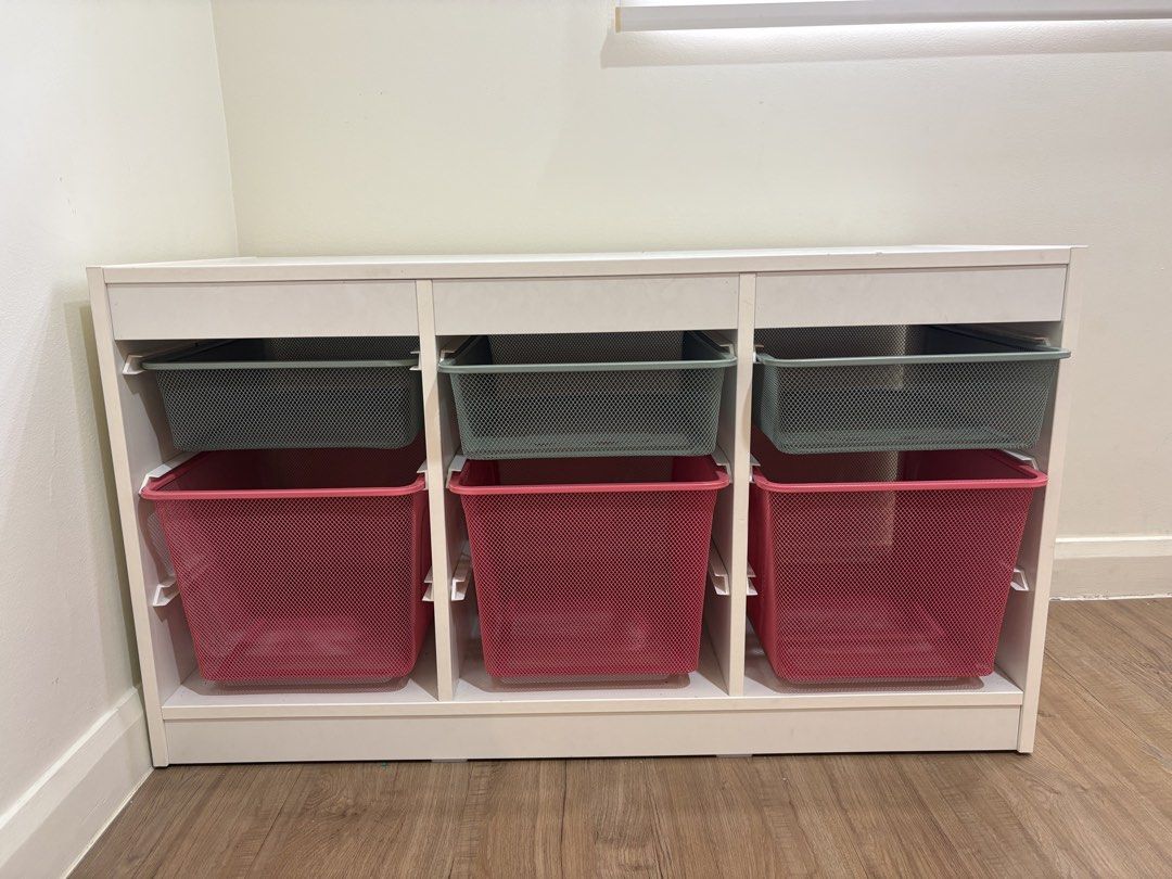 IKEA Trofast Storage Unit with Mesh Bins (Category: Shelves, Cabinets & Racks) located in Quezon City. Submitted by emmakne (Listing ID 1466390227, Image 1). Description: - White wooden frame with 6 pull-out mesh storage bins (3 green on top, 3 pink below) IKEA TROFAST toy storage. In good condition - a few chips on top. Comes with three green metal drawers and 3 pink metal drawers. Dimensions shown in pictures. Selling because we are moving..