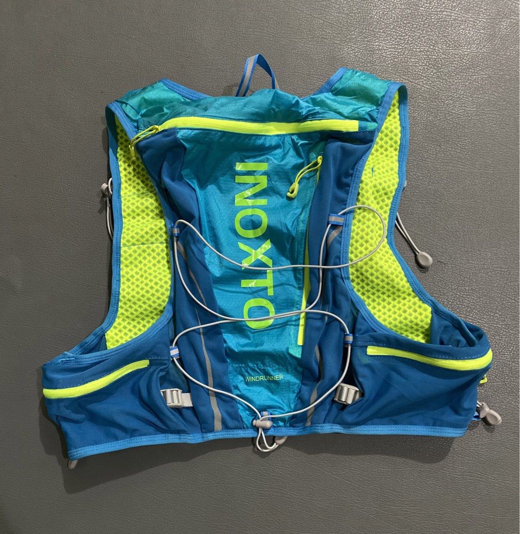 INOXTO Windrunner Hydration Vest Backpack (Category: Activewear) located in Pozorrubio. Submitted by izaykite2g (Listing ID 1466504440, Image 1). Description: - Brand: INOXTO Windrunner Hydration Vest Backpack - Color: Blue with neon yellow accents - Size: L/XL (tag attached at the collar) - Breathable mesh back panel for cooling - Convenient front pockets and zippered upper back compartment - Adjustable bungee cord chest straps for a secure fit 