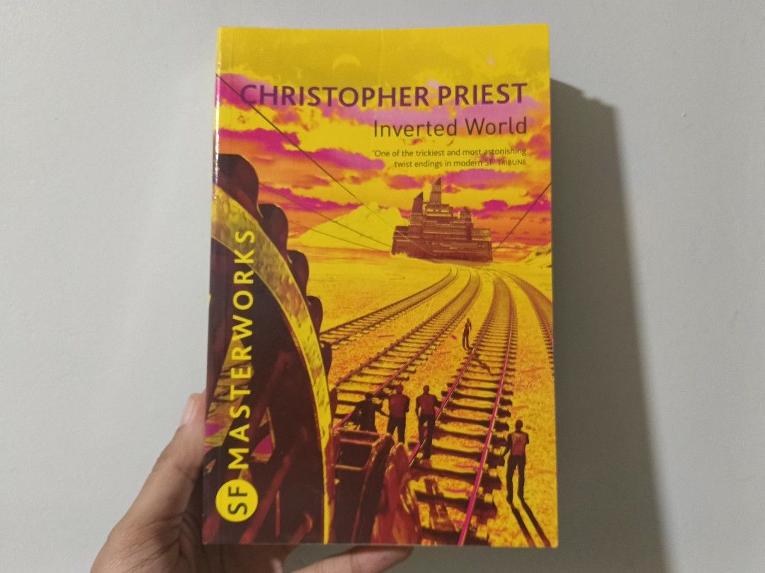 Inverted World by Christopher Priest SF Masterworks Paperback (Category: Storybooks) located in Tagum. Submitted by ria.bantayan (Listing ID 1466438810, Image 1). Description: - Title: Inverted World by Christopher Priest - Edition: SF Masterworks (Gollancz) - Cover Art: Iconic yellow design by Chris Moore - Format: Standard paperback - Condition: Readable copy, great for sci-fi fans - Genre: Classic science fiction (moving city on tracks).