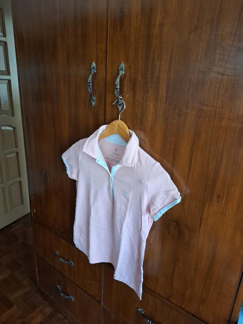 IZOD Pink Polo Shirt Size S (Category: Tshirts & Polo Shirts ) located in Manila. Submitted by bunbun__ (Listing ID 1466414449, Image 2). Description: IZOD short sleeve polo shirt in light pink. Contrast light blue trimming along the collar, placket, and sleeve cuffs. Small embroidered logo on the chest. Button-up collar design. Tag says size S, material is cotton and spandex blend..